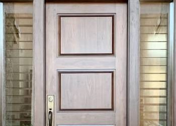 How Can a Custom Wood Front Door Balance Strong Desert Landscaping?